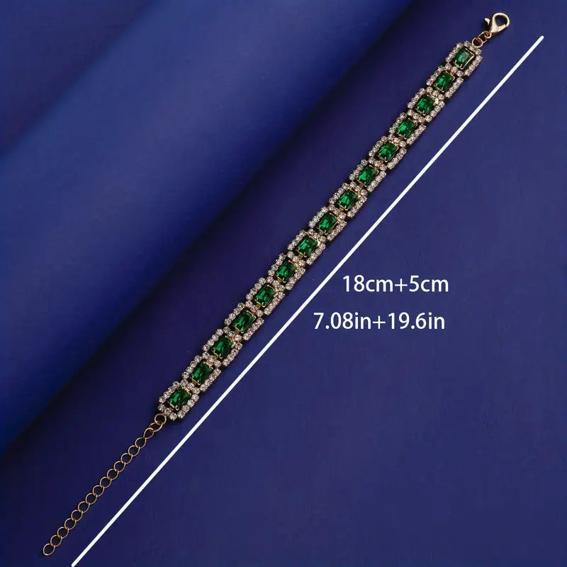 Skinnende armbånd med smaragd